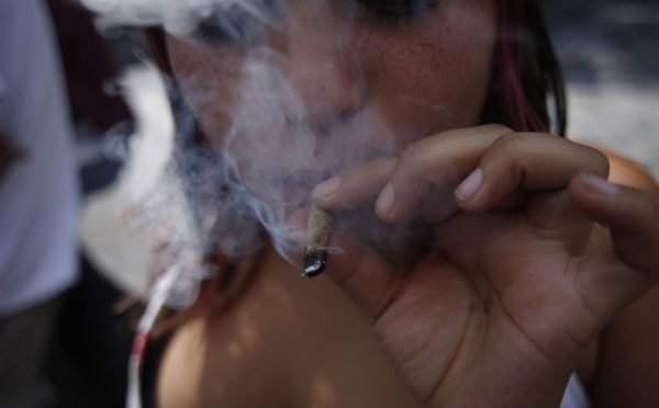 Teen marijuana use -- a topic of much debate as states consider legalizing recreational use of the drug -- has dropped significantly since 2002. Pictured: A supporter of marijuana legalization smokes outside the Supreme Court in Mexico City on Nov. 4, 2015. (Eduardo Verdugo, Associated press file)