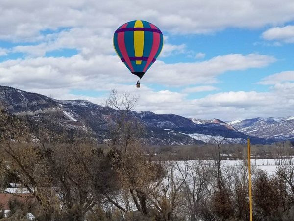 Snowdown Balloon floats over the North Animas Valley during the winter fest of snowdown.